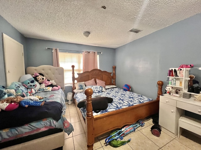 tiled bedroom featuring a textured ceiling