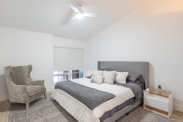 bedroom with hardwood / wood-style flooring, vaulted ceiling, and ceiling fan