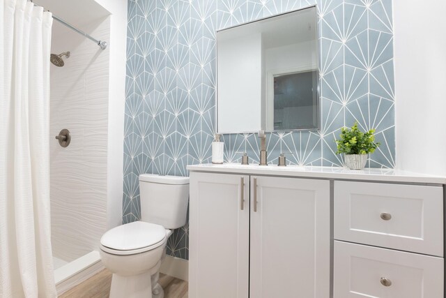 bathroom featuring tile walls, a shower with curtain, toilet, and vanity