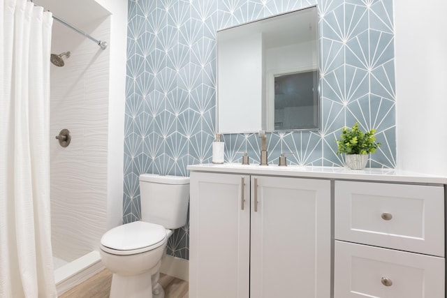 bathroom with hardwood / wood-style flooring, vanity, toilet, and a shower with shower curtain