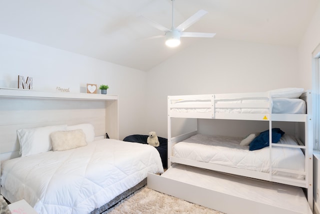 carpeted bedroom featuring lofted ceiling and ceiling fan