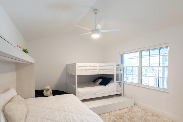 bedroom with carpet floors, lofted ceiling, and ceiling fan