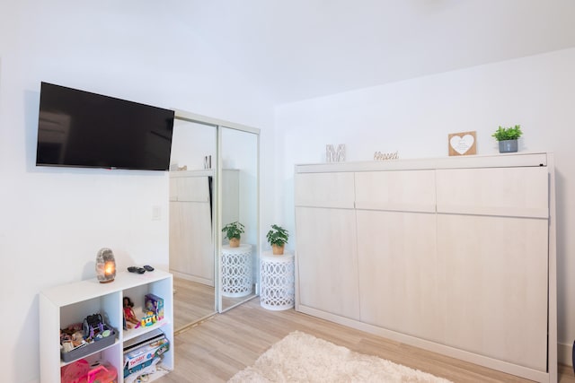 bedroom with a closet and light hardwood / wood-style floors