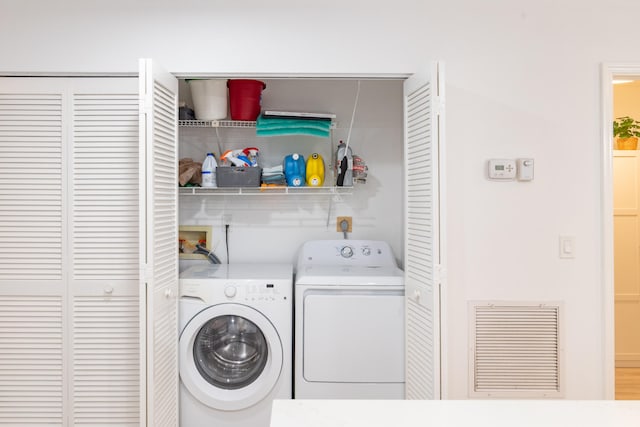 laundry room featuring wood-type flooring and independent washer and dryer