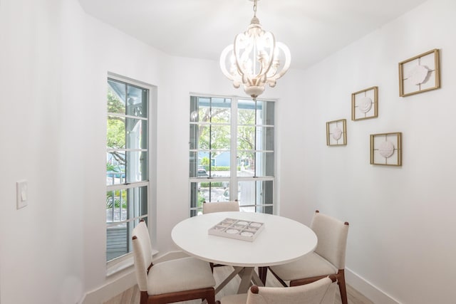 dining space with a wealth of natural light and a chandelier