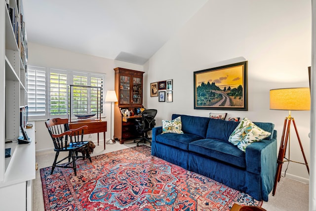 living room featuring light colored carpet, vaulted ceiling, and baseboards