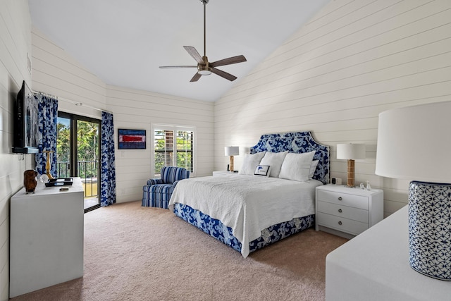 carpeted bedroom featuring a ceiling fan, high vaulted ceiling, wooden walls, and access to outside