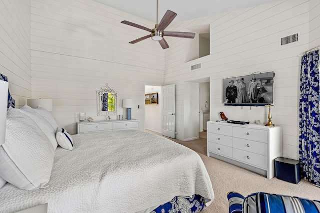 carpeted bedroom with a towering ceiling and ceiling fan