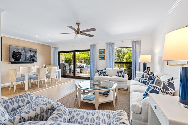 living room featuring ceiling fan, crown molding, hardwood / wood-style floors, and plenty of natural light