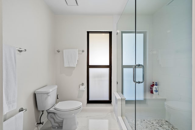 bathroom with tile patterned floors, a shower with shower door, and toilet