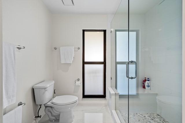 bathroom featuring a shower stall, toilet, and marble finish floor