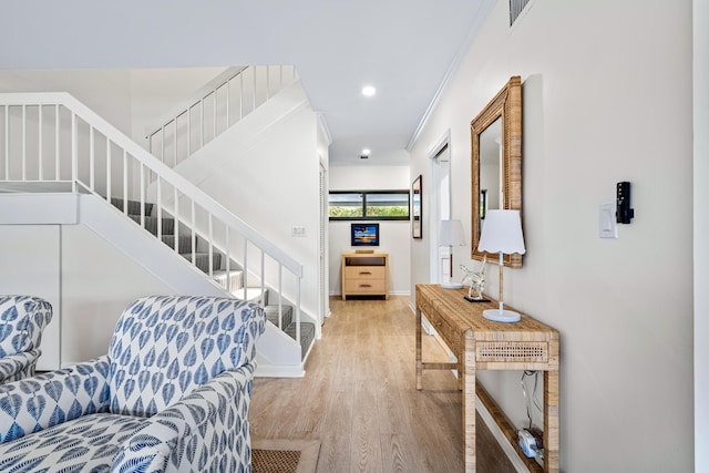 entryway with ornamental molding, baseboards, stairs, wood finished floors, and recessed lighting