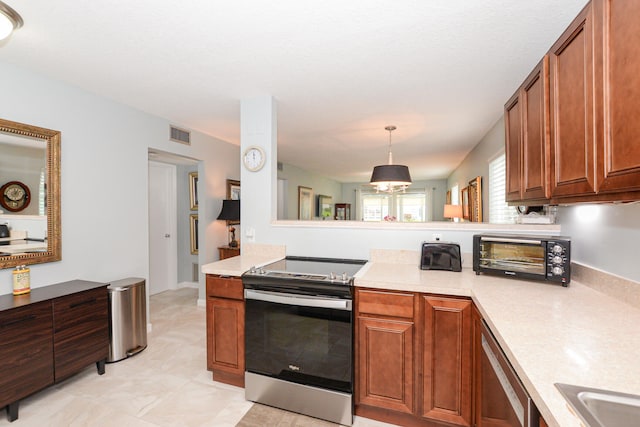 kitchen featuring light tile patterned floors, pendant lighting, sink, stainless steel range with electric stovetop, and kitchen peninsula