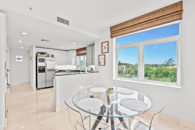 tiled dining area featuring sink