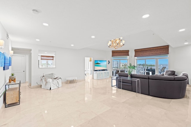 living room featuring light tile patterned floors and a chandelier