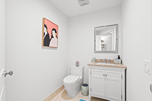 bathroom with vanity, tile patterned flooring, and toilet