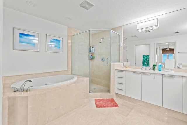 bathroom with tile patterned flooring, a textured ceiling, vanity, ceiling fan, and independent shower and bath