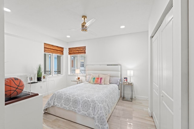 bedroom featuring light hardwood / wood-style flooring, a closet, and ceiling fan