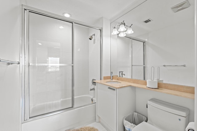 full bathroom with vanity, tile patterned flooring, bath / shower combo with glass door, and toilet