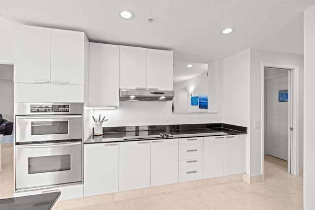 kitchen with black electric stovetop, white cabinetry, stainless steel double oven, and light tile patterned floors