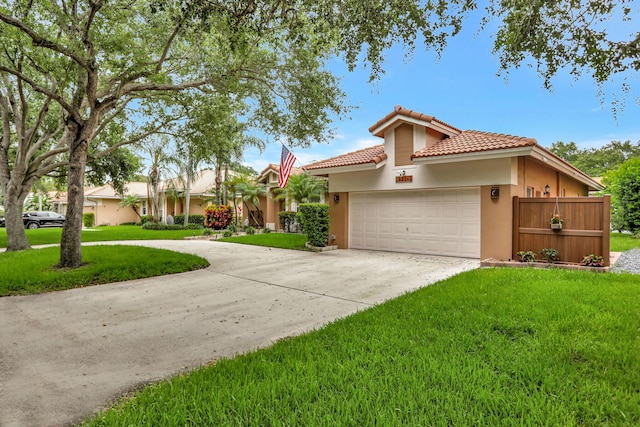 view of front of home with a garage and a front lawn