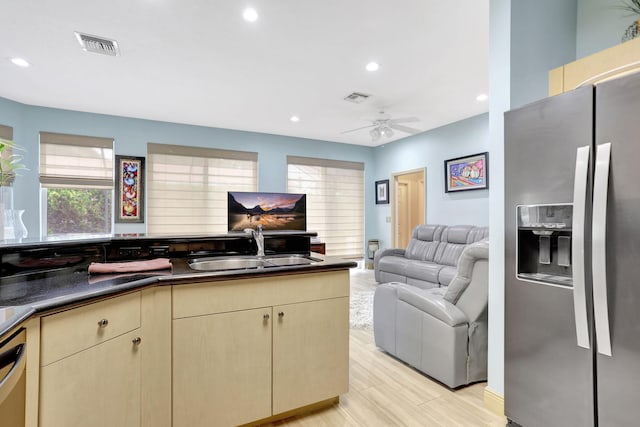 kitchen featuring sink, cream cabinets, stainless steel fridge with ice dispenser, and ceiling fan