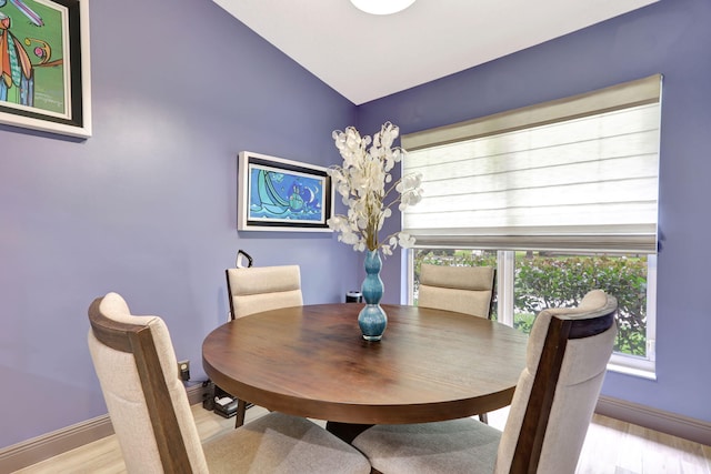 dining area featuring light hardwood / wood-style flooring and lofted ceiling