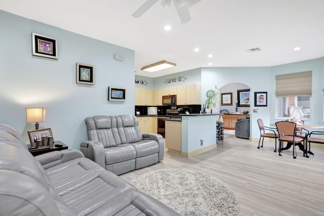 living room with ceiling fan and light hardwood / wood-style floors