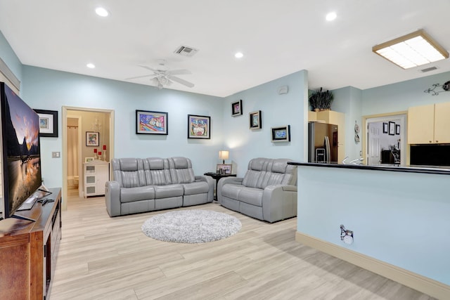 living room with ceiling fan and light wood-type flooring