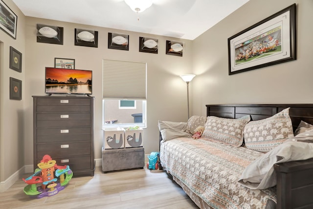 bedroom with ceiling fan and light wood-type flooring