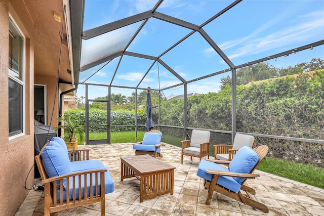 view of patio with an outdoor living space and a lanai