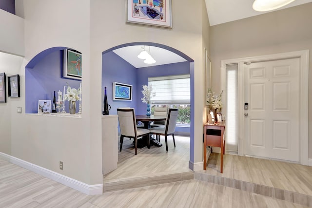 entryway featuring light hardwood / wood-style floors and vaulted ceiling