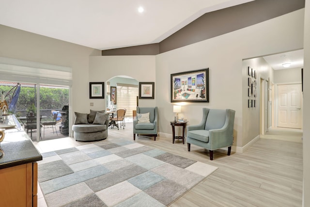 living room featuring light hardwood / wood-style flooring and lofted ceiling