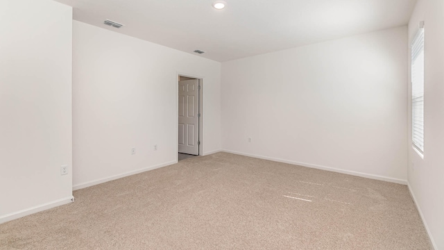 spare room with light colored carpet