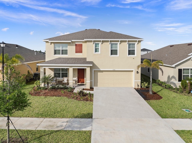 view of property featuring a garage and a front lawn