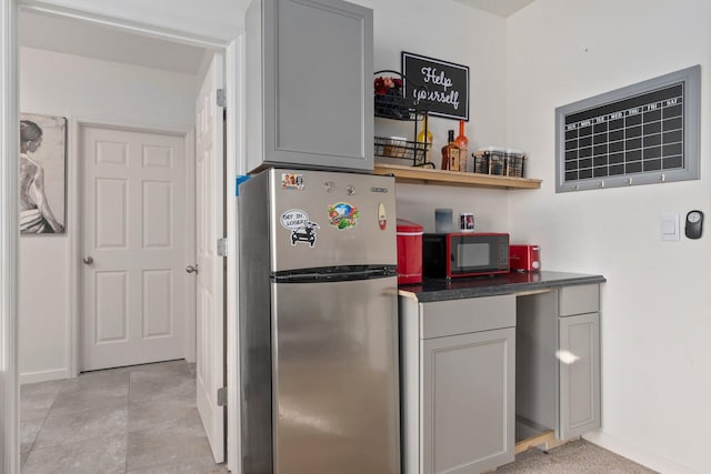 kitchen featuring stainless steel fridge and gray cabinets