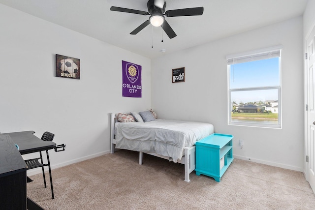 bedroom featuring ceiling fan and light carpet