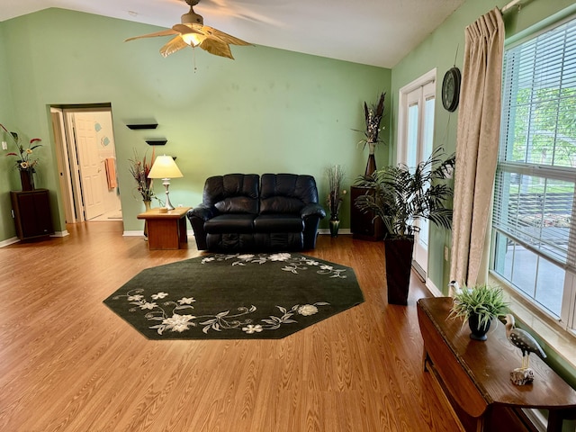 living room featuring vaulted ceiling, ceiling fan, and hardwood / wood-style flooring