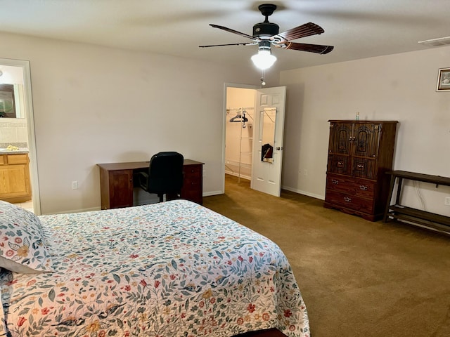 bedroom with dark colored carpet, ceiling fan, and ensuite bath