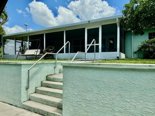 view of pool featuring a sunroom