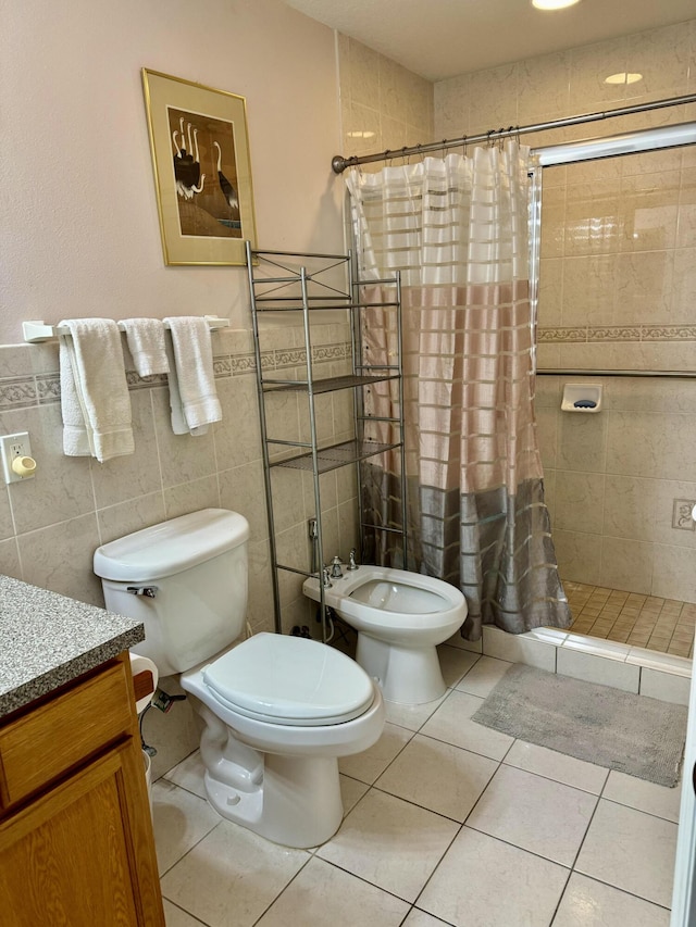 bathroom featuring toilet, tile walls, tile patterned floors, a shower with shower curtain, and vanity