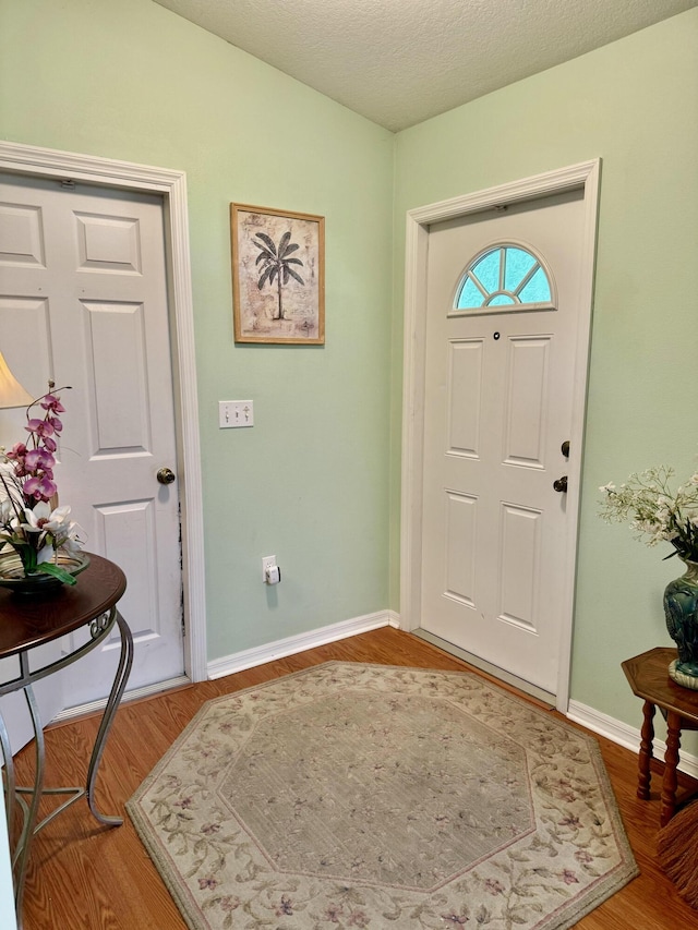 entrance foyer featuring hardwood / wood-style flooring and a textured ceiling