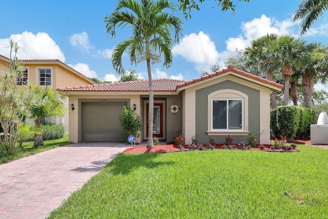 mediterranean / spanish-style home featuring a front yard and a garage