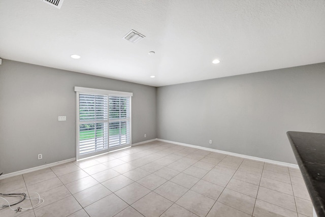 spare room with light tile patterned floors