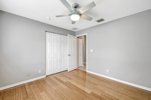 unfurnished bedroom with light hardwood / wood-style floors, a closet, and ceiling fan