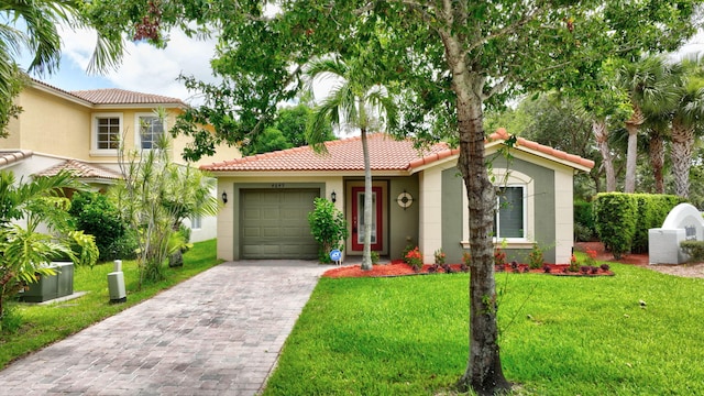 view of front of home with a garage and a front lawn