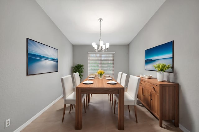 dining space featuring an inviting chandelier, tile patterned flooring, and vaulted ceiling