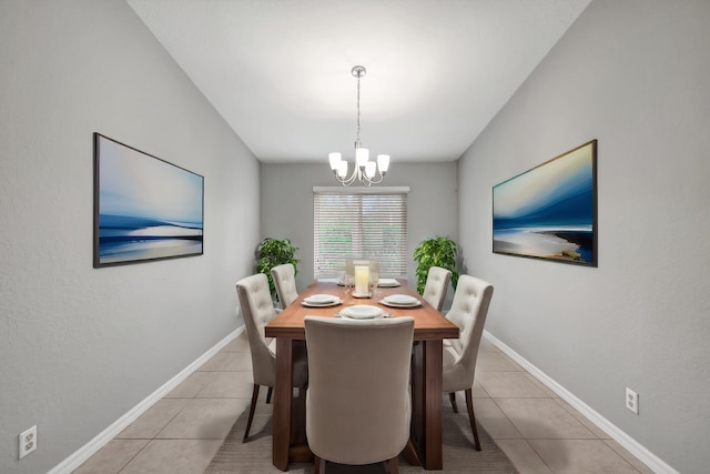 dining area featuring light tile patterned flooring and a chandelier