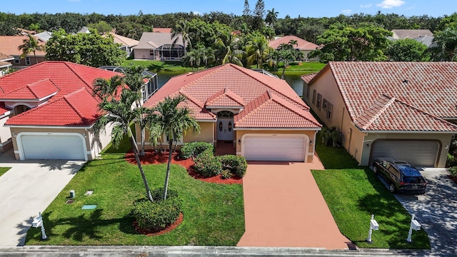 mediterranean / spanish home with a garage and a front yard