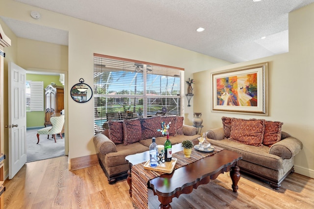 living room featuring light carpet and a textured ceiling